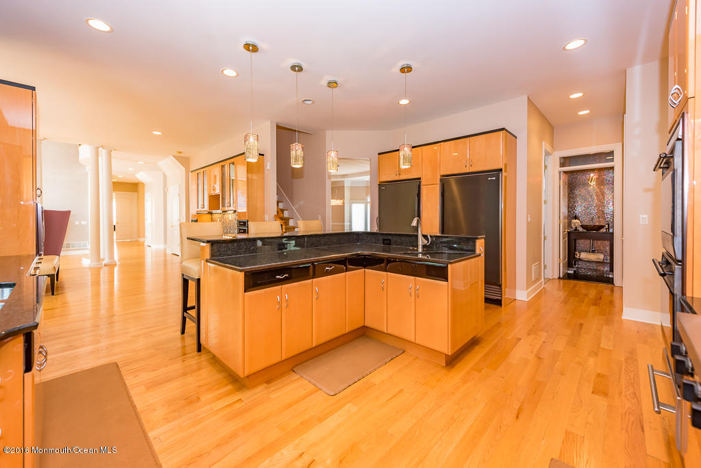 500 Farm Bridge Road Marlboro, NJ 07746 - Photo 18 of 57 a large kitchen with stainless steel appliances kitchen island granite countertop a large cabinets and a sink