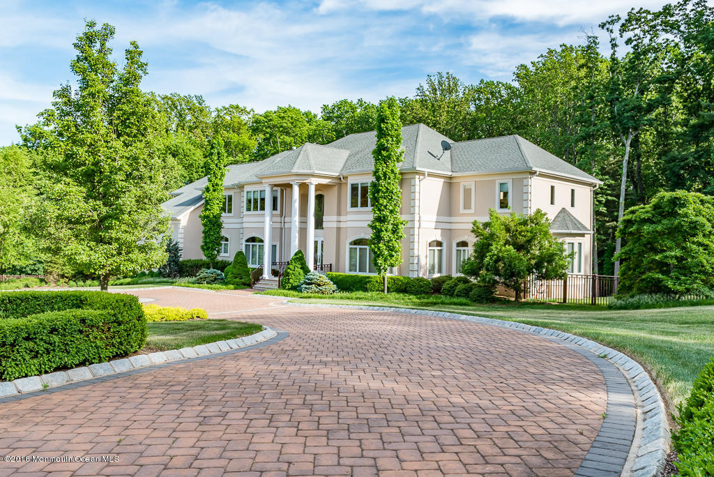 500 Farm Bridge Road Marlboro, NJ 07746 - Photo 3 of 57 a front view of a house with a yard and potted plants