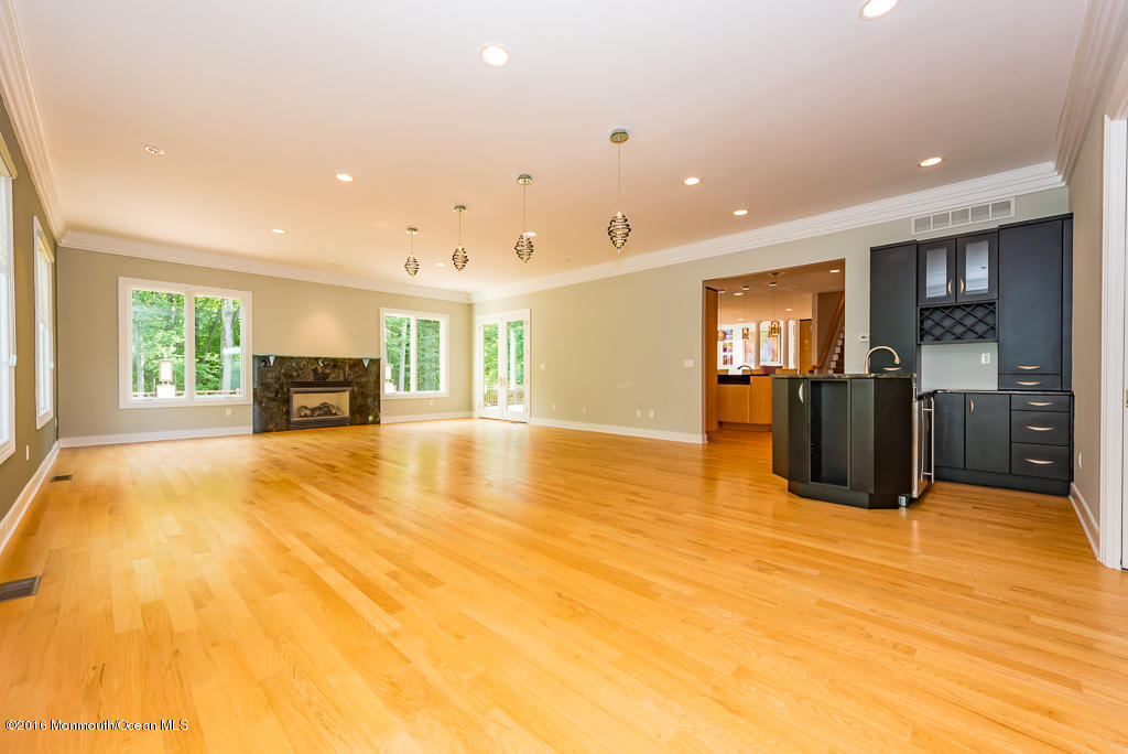500 Farm Bridge Road Marlboro, NJ 07746 - Photo 23 of 57 a big room with wooden floor and furniture