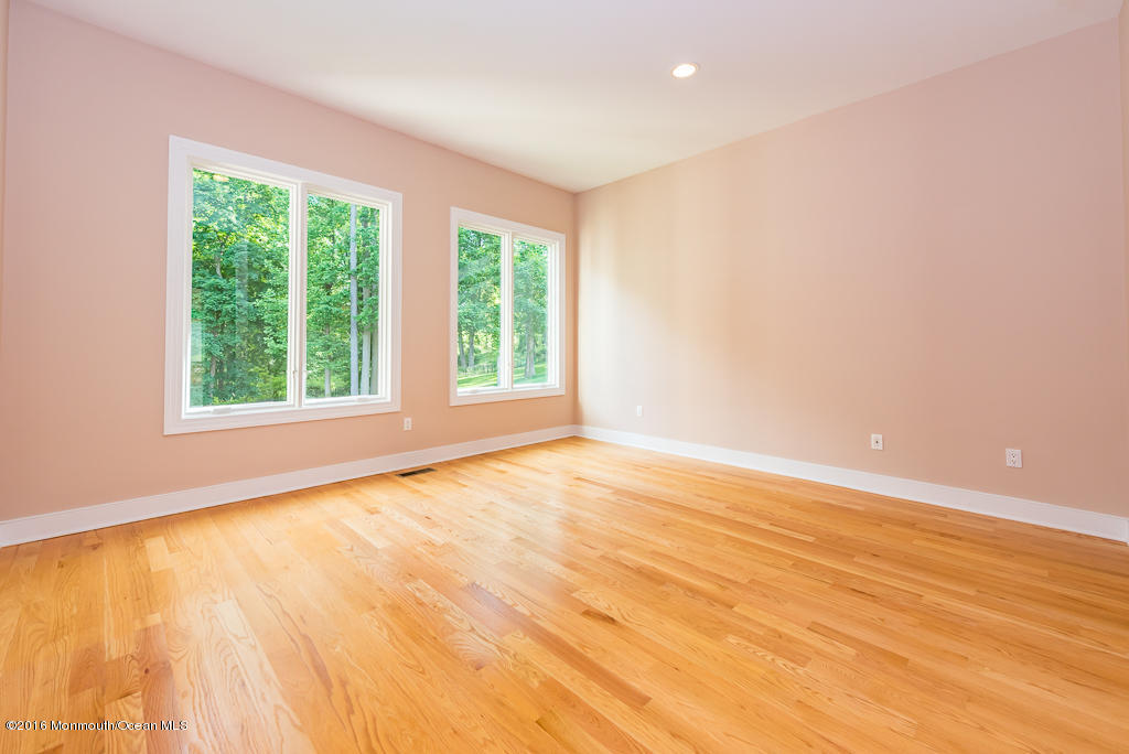 500 Farm Bridge Road Marlboro, NJ 07746 - Photo 24 of 57 an empty room with wooden floor and windows