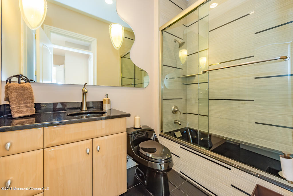 500 Farm Bridge Road Marlboro, NJ 07746 - Photo 26 of 57 a bathroom with a granite countertop sink a mirror and a shower
