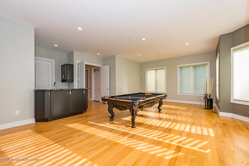 500 Farm Bridge Road Marlboro, NJ 07746 - Photo 27 of 57 a living room with a table and a flat screen tv