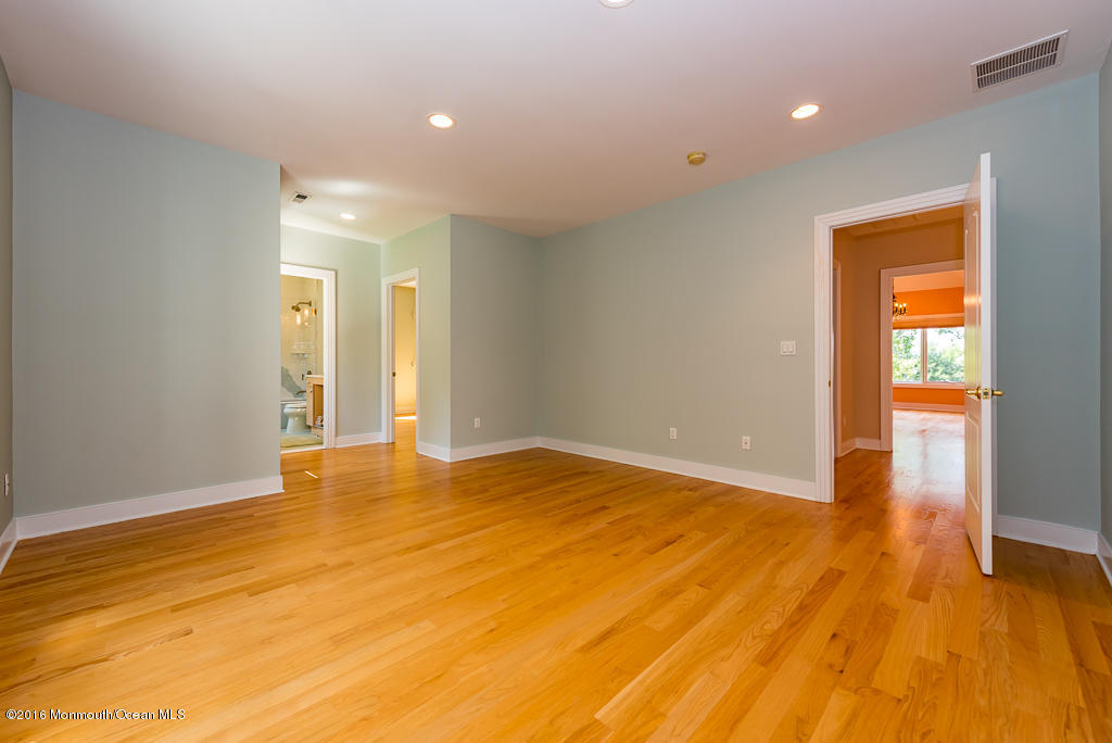 500 Farm Bridge Road Marlboro, NJ 07746 - Photo 31 of 57 a view of an empty room with wooden floor and a window