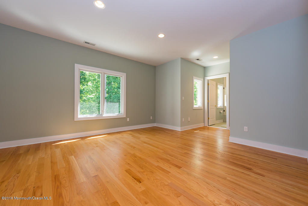 500 Farm Bridge Road Marlboro, NJ 07746 - Photo 32 of 57 an empty room with wooden floor and windows