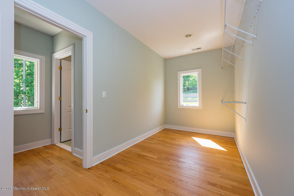 500 Farm Bridge Road Marlboro, NJ 07746 - Photo 34 of 57 a view of an empty room with wooden floor and a window