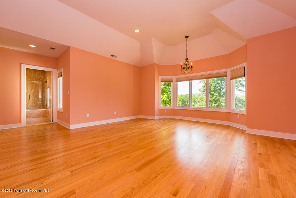 500 Farm Bridge Road Marlboro, NJ 07746 - Photo 35 of 57 a view of an empty room with wooden floor and a window