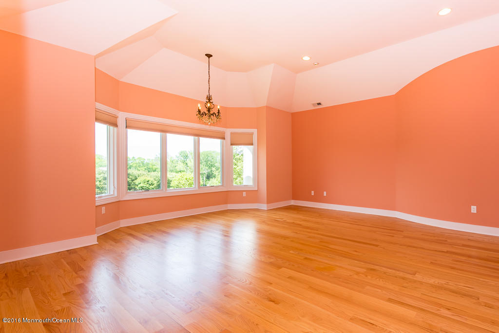 500 Farm Bridge Road Marlboro, NJ 07746 - Photo 36 of 57 a view of an empty room with wooden floor and a window