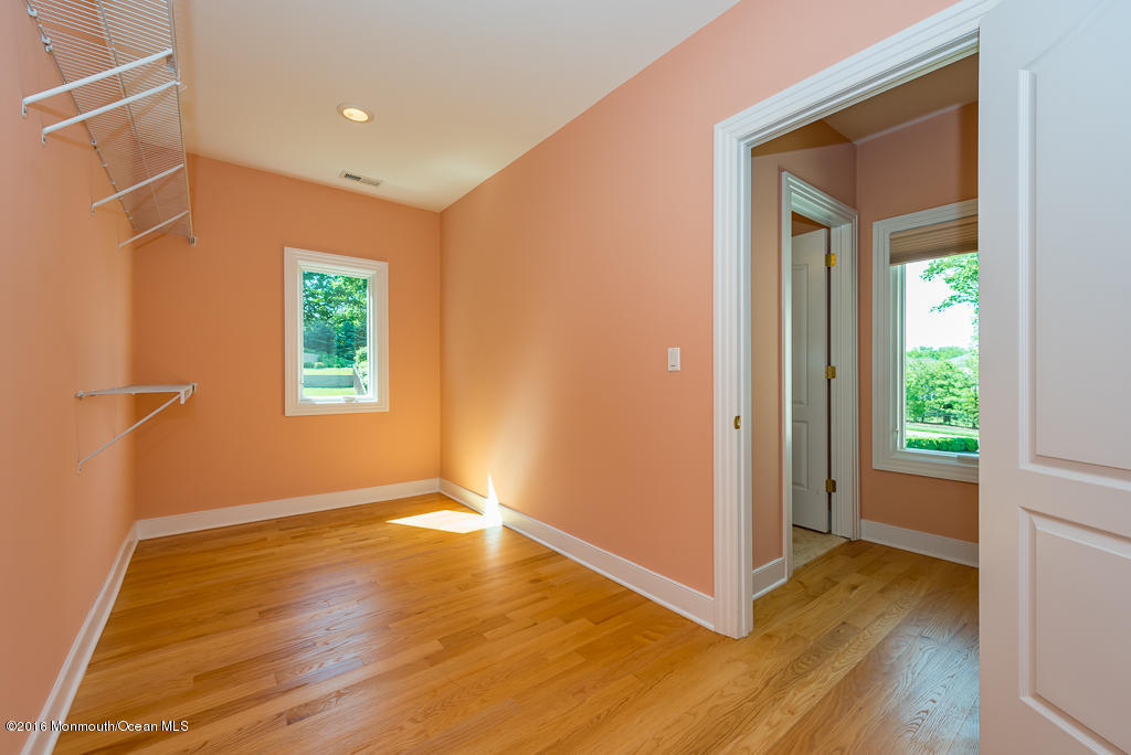 500 Farm Bridge Road Marlboro, NJ 07746 - Photo 38 of 57 a view of an empty room with window and wooden floor