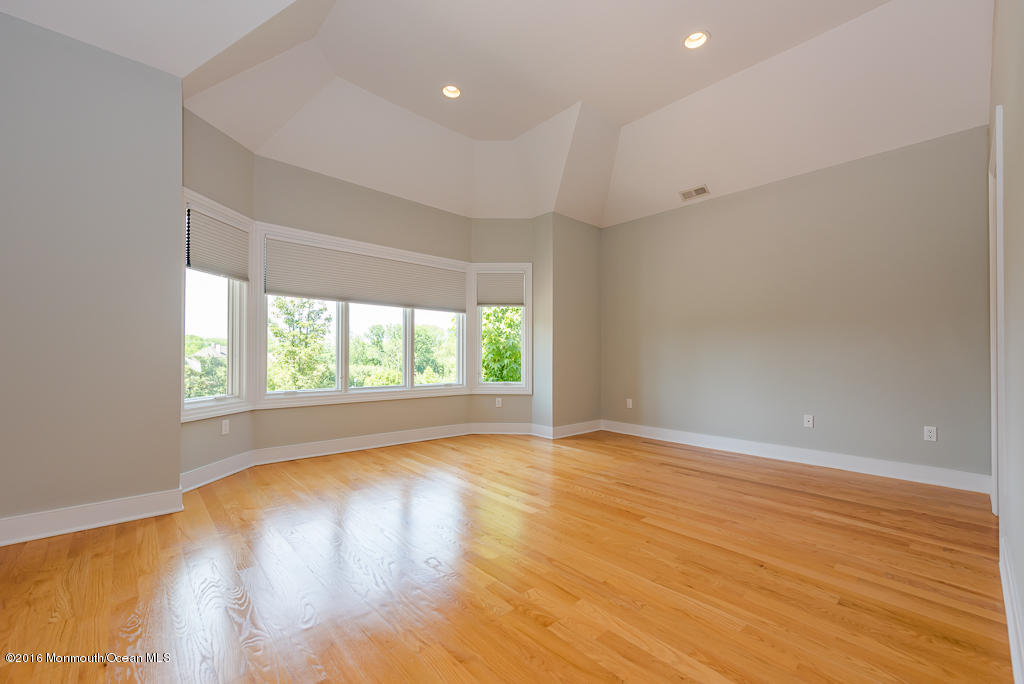 500 Farm Bridge Road Marlboro, NJ 07746 - Photo 39 of 57 an empty room with wooden floor and windows