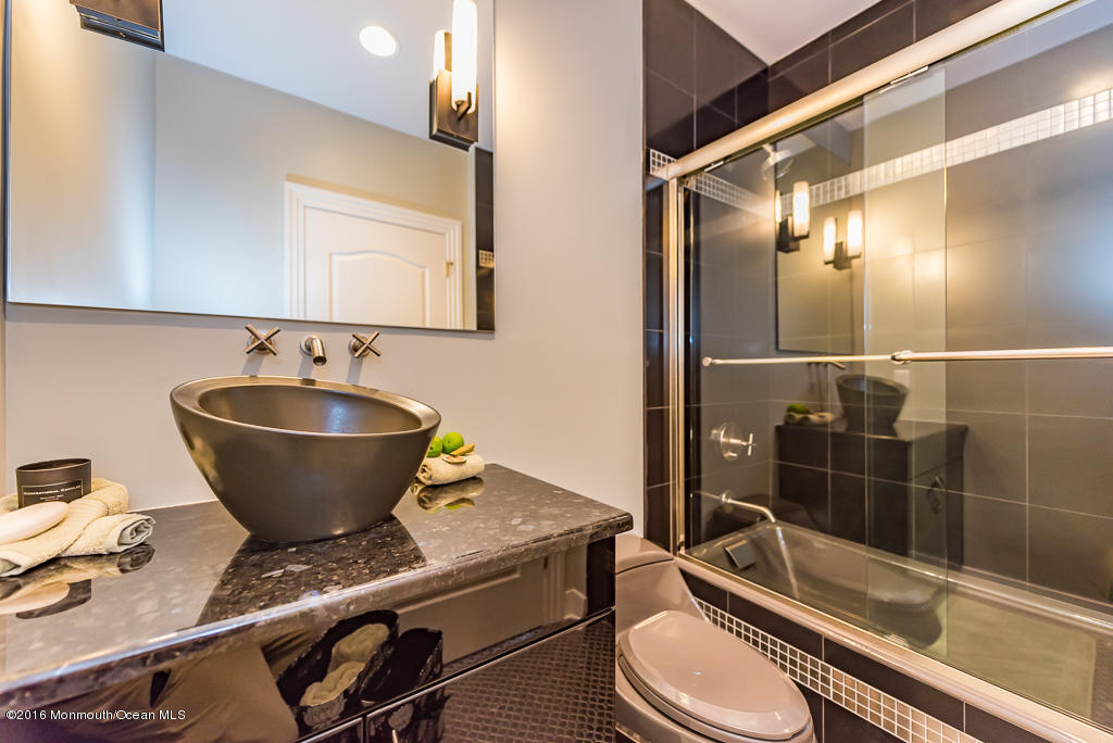500 Farm Bridge Road Marlboro, NJ 07746 - Photo 41 of 57 a bathroom with a granite countertop sink and a mirror