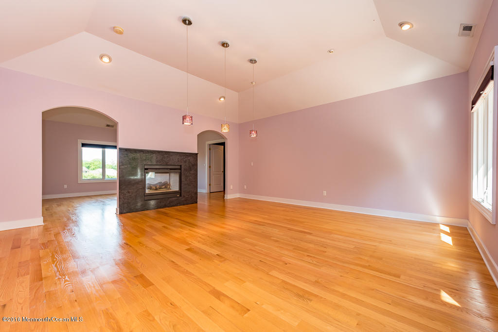 500 Farm Bridge Road Marlboro, NJ 07746 - Photo 44 of 57 a view of empty room with wooden floor and fireplace