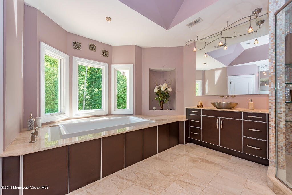 500 Farm Bridge Road Marlboro, NJ 07746 - Photo 47 of 57 a kitchen with stainless steel appliances granite countertop a sink and stove