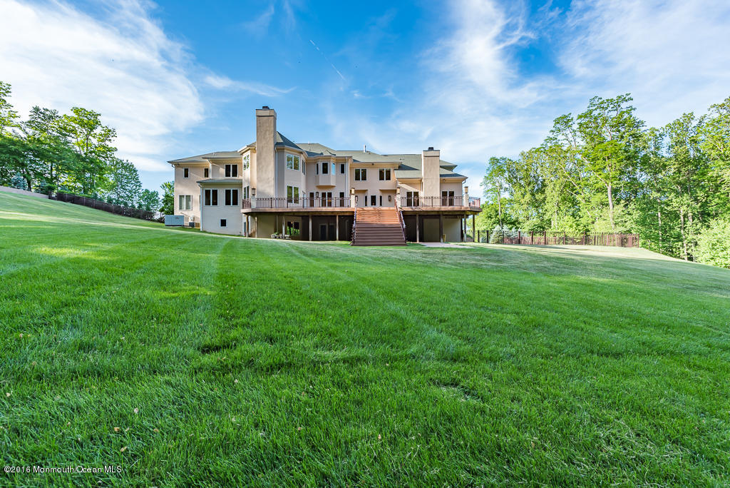 500 Farm Bridge Road Marlboro, NJ 07746 - Photo 54 of 57 a view of a house with a big yard and large trees