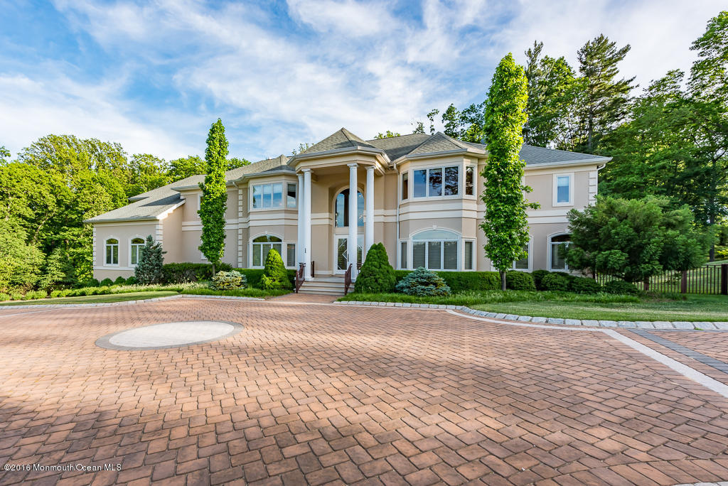 500 Farm Bridge Road Marlboro, NJ 07746 - Photo 56 of 57 a front view of a house with a yard and a garage