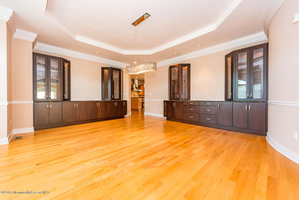 500 Farm Bridge Road Marlboro, NJ 07746 - Photo 9 of 57 a view of an empty room with a fireplace and windows