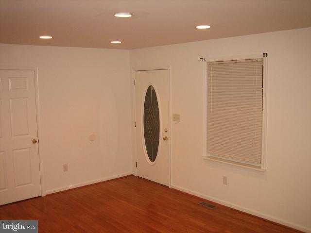 1213 Krueger Avenue Rosedale, MD 21237 - Photo 14 of 27 a view of a room with wooden floor and white wall