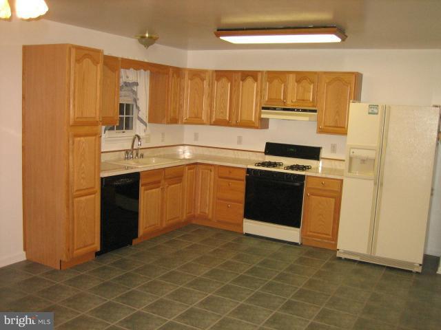 1213 Krueger Avenue Rosedale, MD 21237 - Photo 16 of 27 a kitchen with stainless steel appliances granite countertop a stove a sink and a refrigerator
