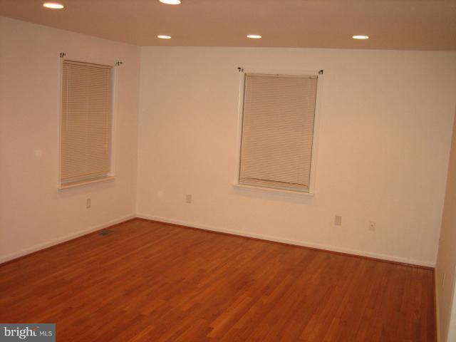 1213 Krueger Avenue Rosedale, MD 21237 - Photo 21 of 27 an empty room with wooden floor and windows