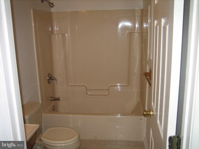 1213 Krueger Avenue Rosedale, MD 21237 - Photo 6 of 27 a bathroom with a granite countertop bathtub shower sink vanity and toilet