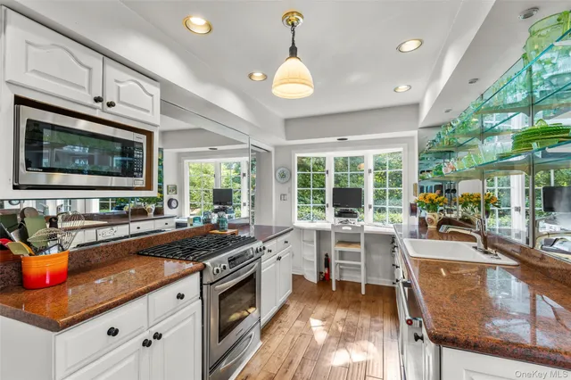 a kitchen with a stove a sink and a microwave