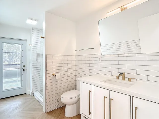 a view of a livingroom with an empty space & a window