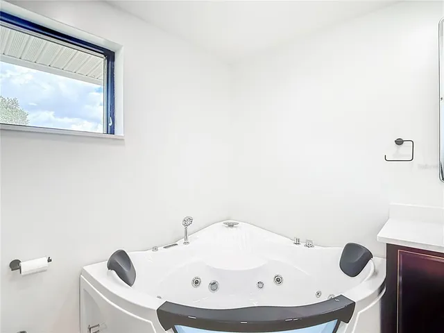 a view of a room with wooden floor closet and a ceiling fan