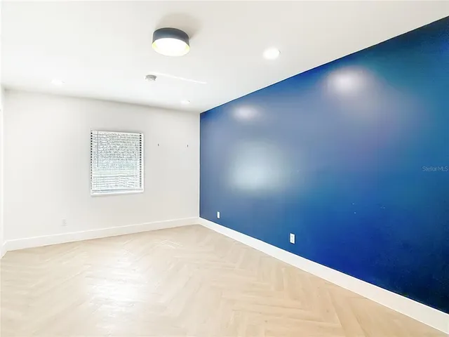a kitchen with stainless steel appliances white cabinets and a refrigerator