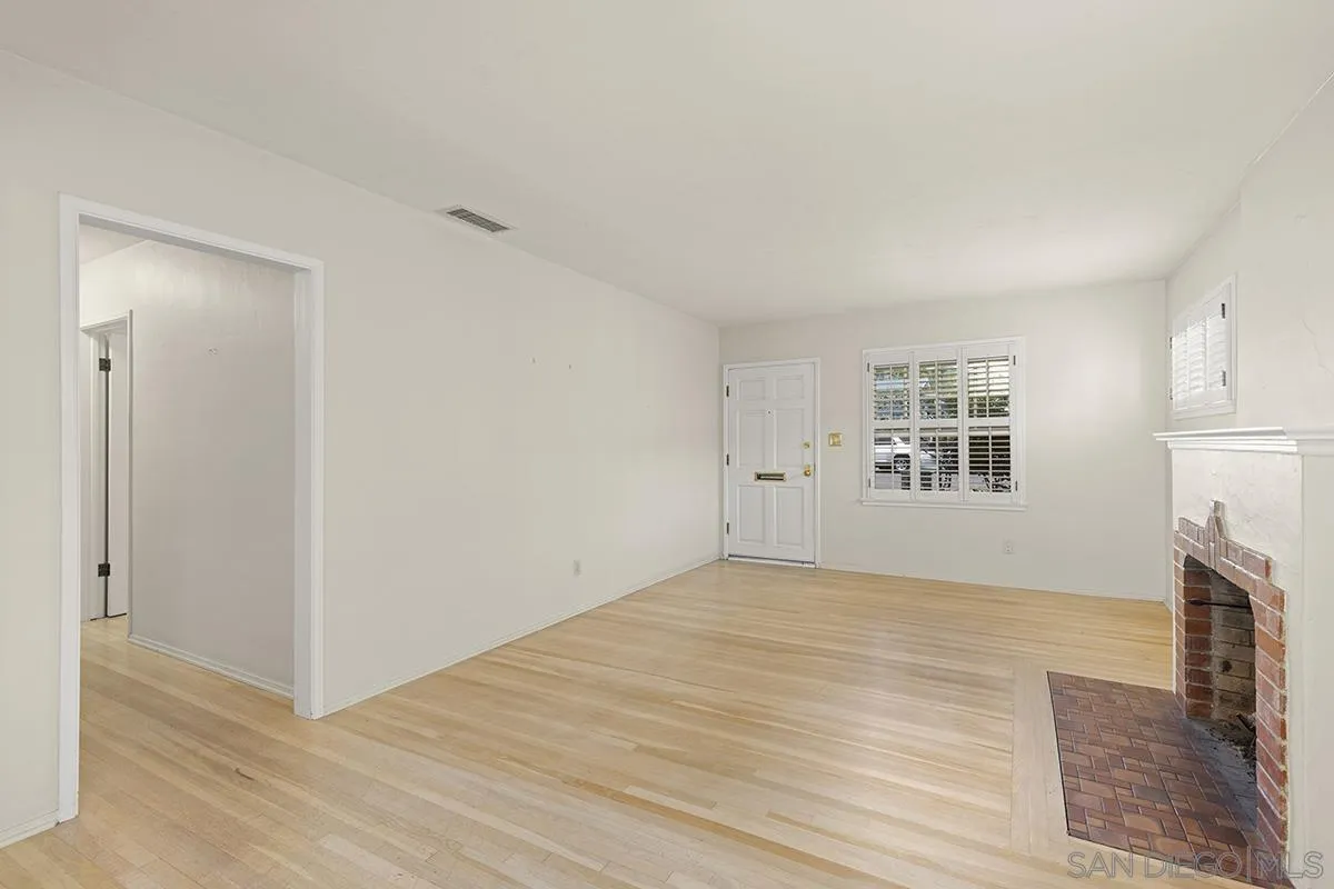 5532 Bellevue Avenue La Jolla, CA 92037 - Photo 5 of 26 a view of empty room with fireplace and wooden floor