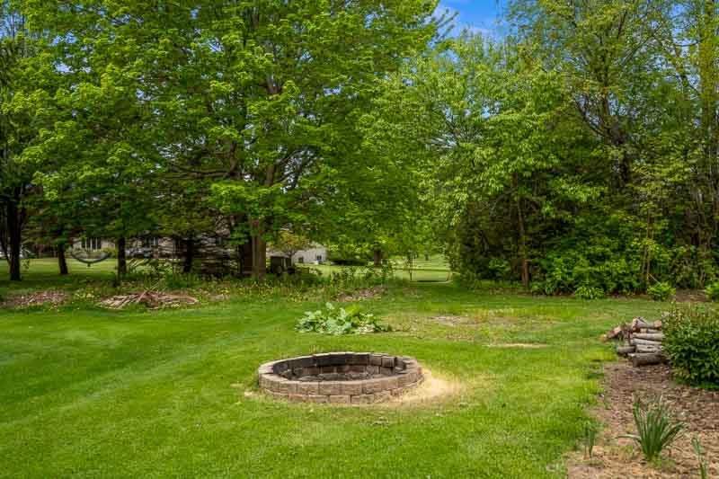 8833 West Ridge Drive Belvidere, IL 61008 - Photo 11 of 65 a backyard of a house with a yard and outdoor seating