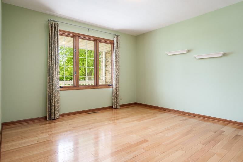 8833 West Ridge Drive Belvidere, IL 61008 - Photo 29 of 65 a view of an empty room with wooden floor and a window