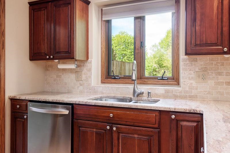 8833 West Ridge Drive Belvidere, IL 61008 - Photo 36 of 65 a sink with granite countertop cabinets and window