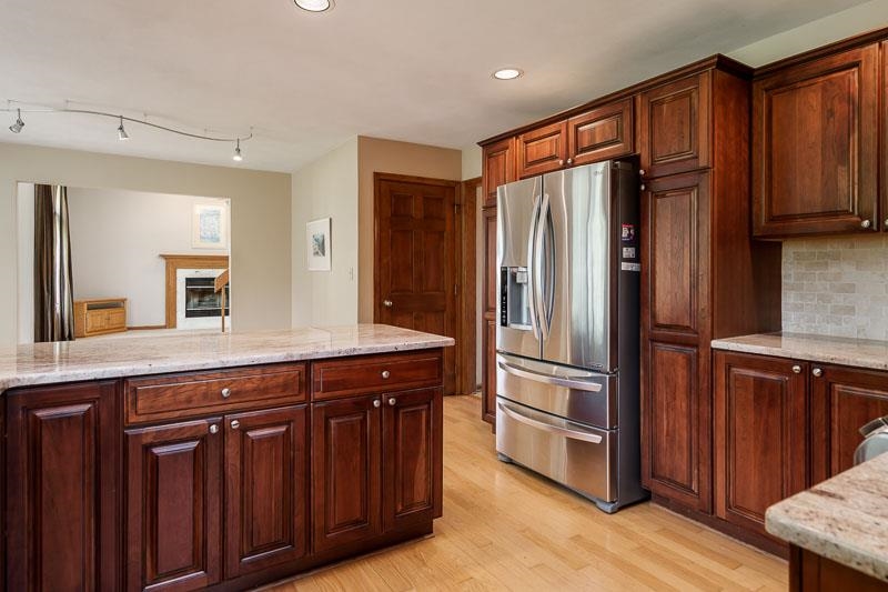 8833 West Ridge Drive Belvidere, IL 61008 - Photo 38 of 65 a kitchen with stainless steel appliances granite countertop a refrigerator and a sink