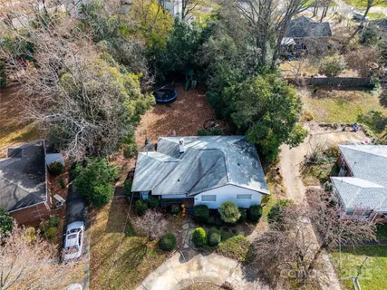 an aerial view of a house with a yard basket ball court and outdoor seating
