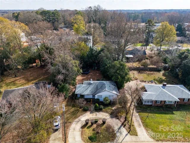 an aerial view of house with yard and swimming pool