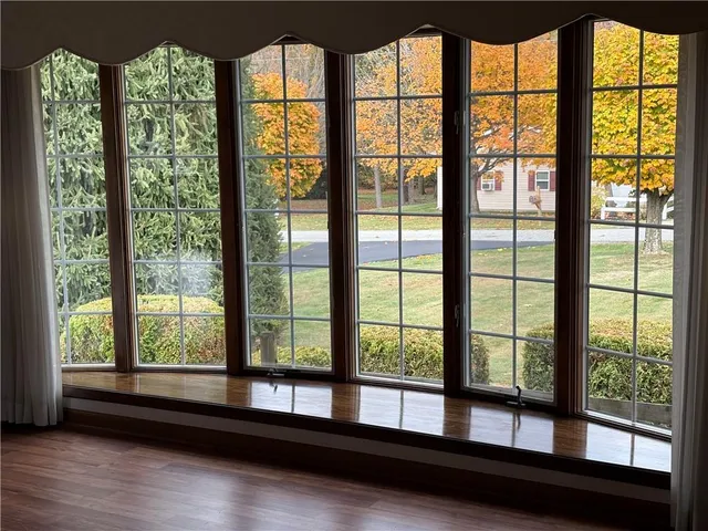 a room with large windows and furniture