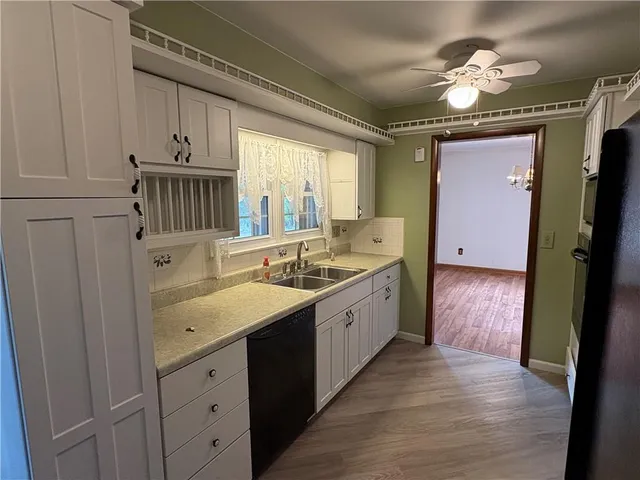 a kitchen with a sink cabinets and window