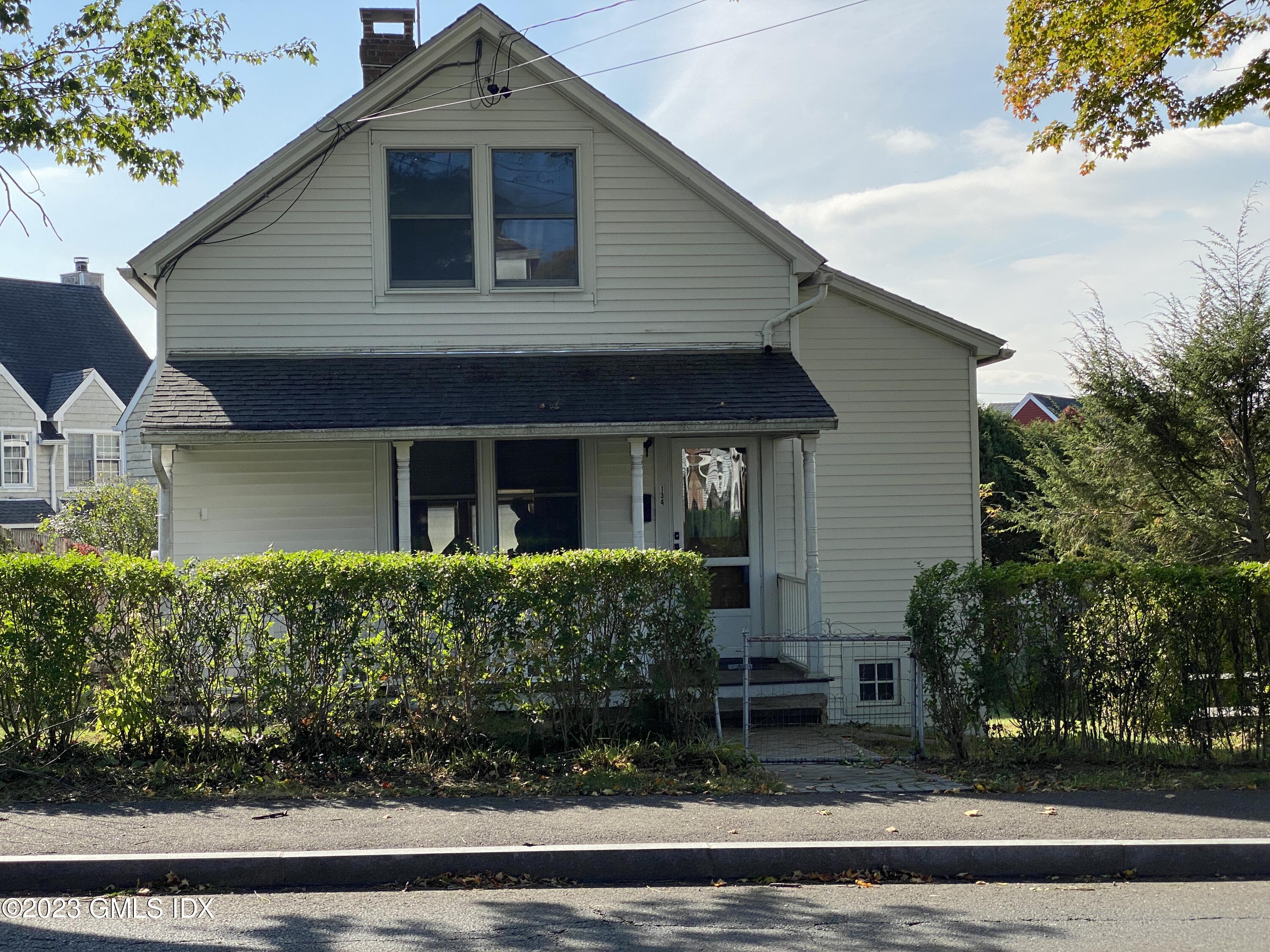 134 Byram Road Greenwich, CT 06830 - Photo 1 of 15 a front view of a house with garden
