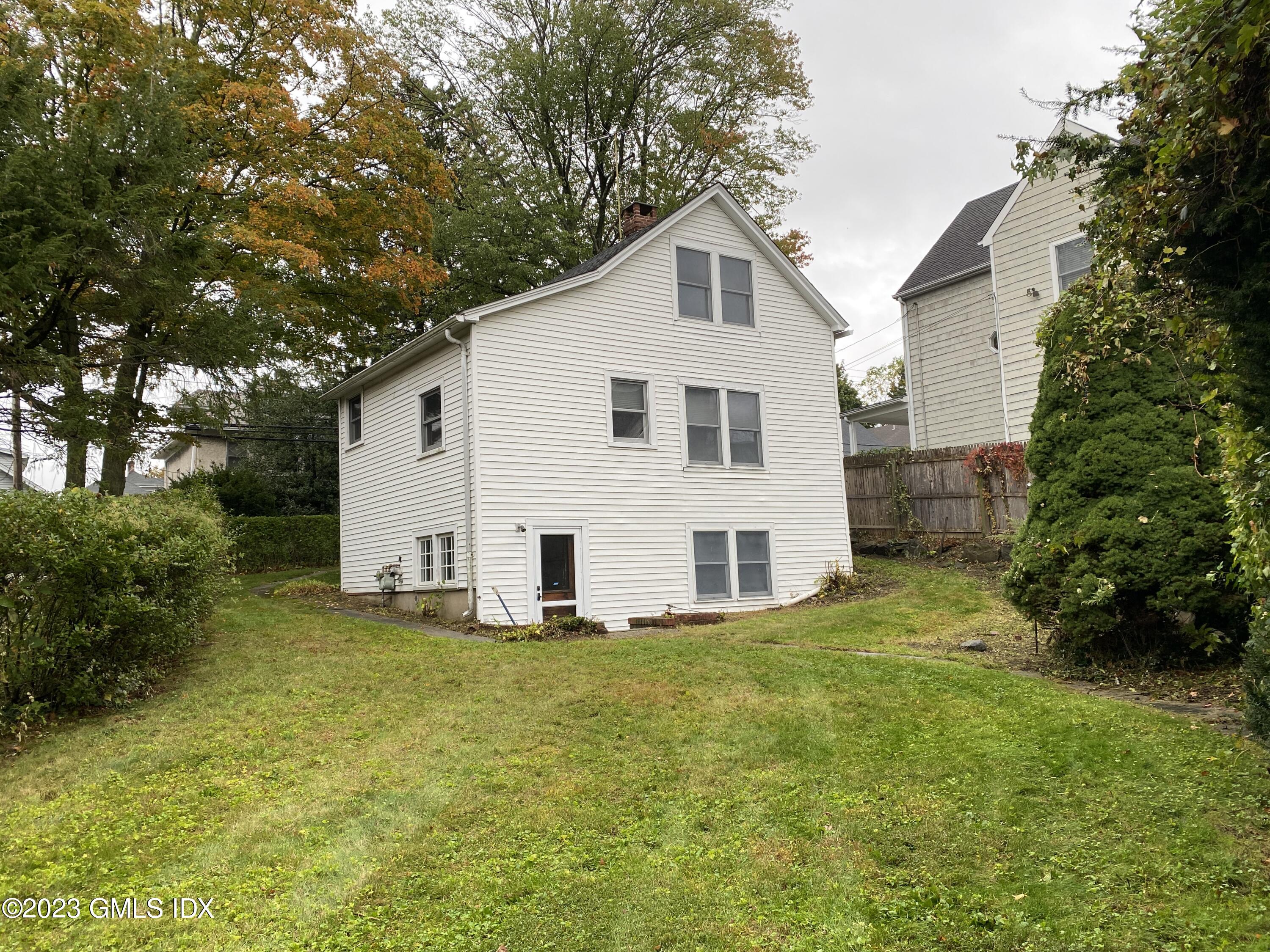 134 Byram Road Greenwich, CT 06830 - Photo 14 of 15 a view of a house with a yard
