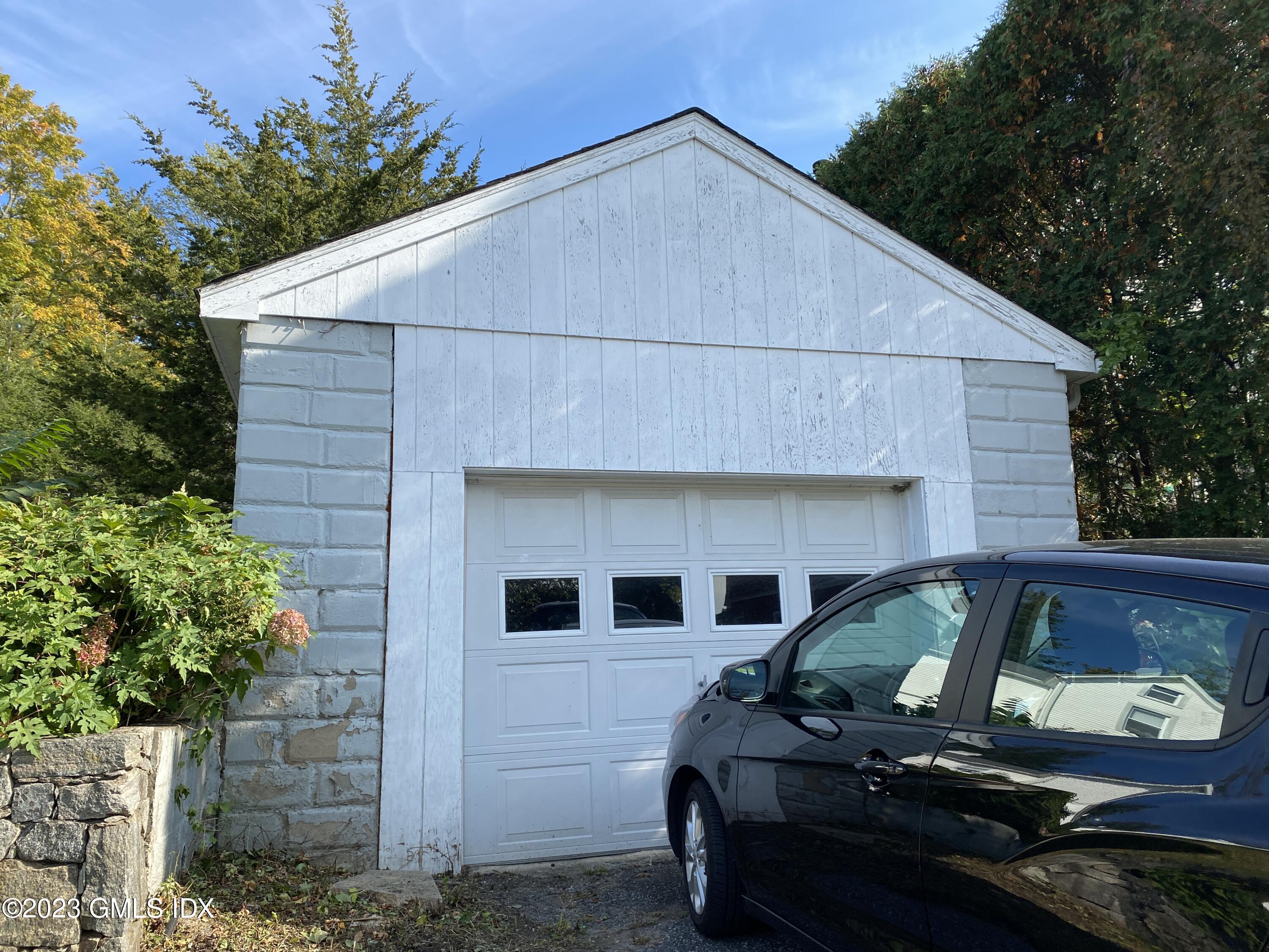 134 Byram Road Greenwich, CT 06830 - Photo 15 of 15 a car parked in front of white house