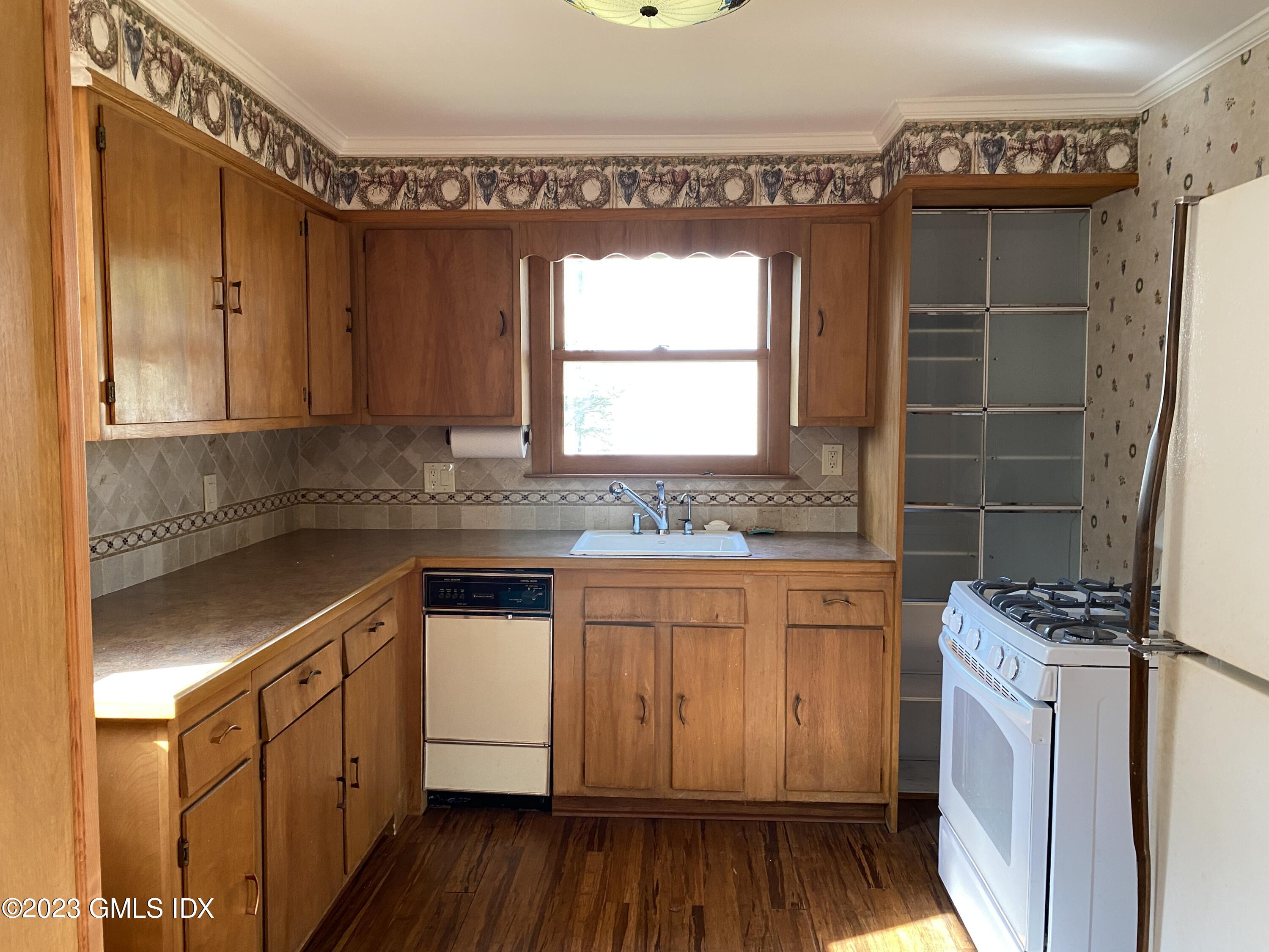134 Byram Road Greenwich, CT 06830 - Photo 6 of 15 a kitchen with granite countertop a sink cabinets and wooden floor