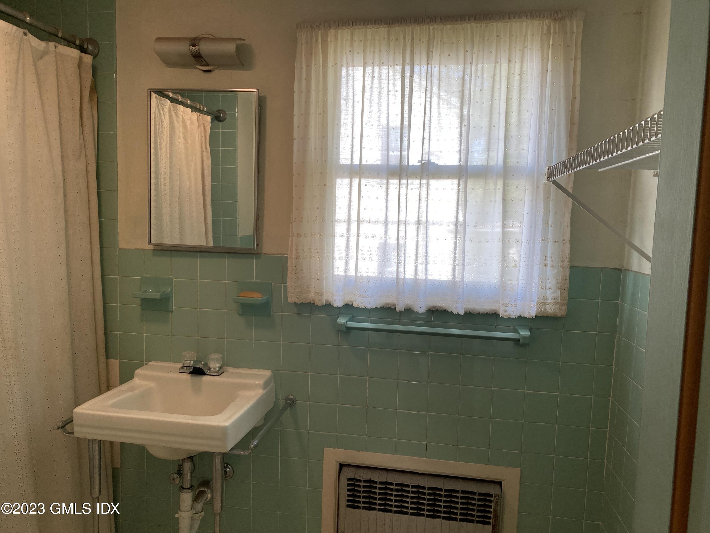 134 Byram Road Greenwich, CT 06830 - Photo 7 of 15 a bathroom with a sink a toilet and a mirror