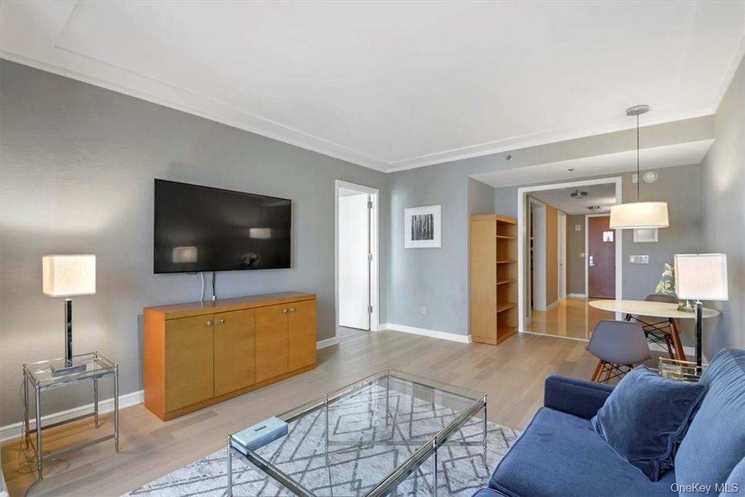 1 Renaissance Square, Unit 7B White Plains, NY 10601 - Photo 2 of 10 a living room with furniture and a flat screen tv