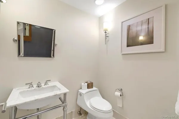 a white toilet sitting next to a bathroom sink