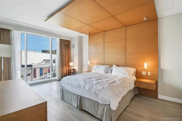 a bedroom with a large bed and a large window