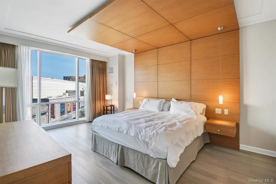 1 Renaissance Square, Unit 7B White Plains, NY 10601 - Photo 6 of 10 a bedroom with a large bed and a large window