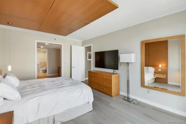 a bedroom with a bed and a television