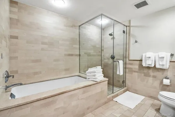 a bathroom with a tub sink and toilet