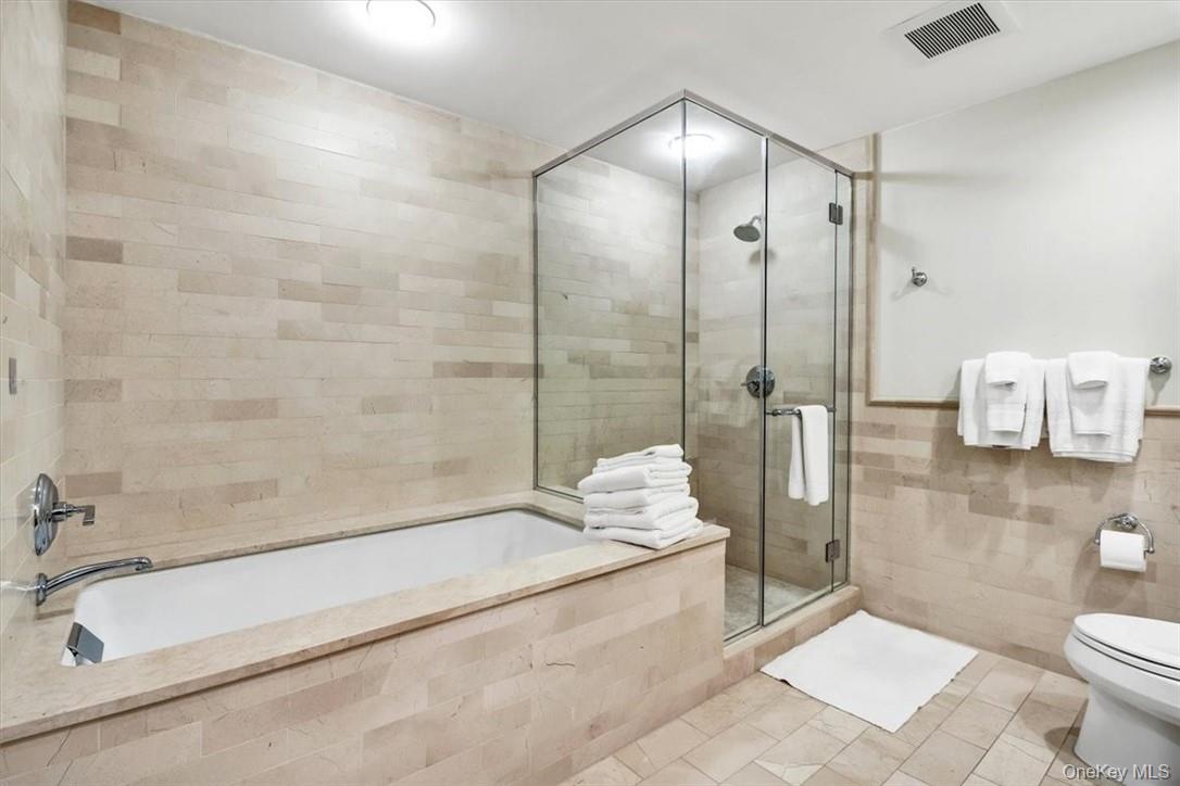 1 Renaissance Square, Unit 7B White Plains, NY 10601 - Photo 10 of 10 a bathroom with a tub sink and toilet