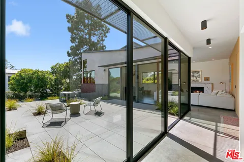 a view of a patio with chairs and a table