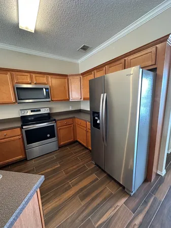 a kitchen with stainless steel appliances granite countertop a sink and stove top oven